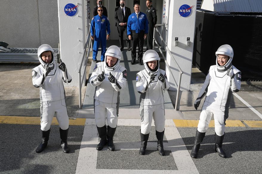 Astronauts, from left, Oleg Platonov, of Russia, Mike Fincke, Zena Cardman, and Kimiya Yui, of Japan, pose for a photo as they leave the Operations and Checkout Building for a trip the Kennedy Space Center's Launch Pad 39-A and a planned liftoff on a SpaceX Falcon 9 rocket Friday, Aug. 1, 2025, in Cape Canaveral , Fla. (AP Photo/John Raoux)