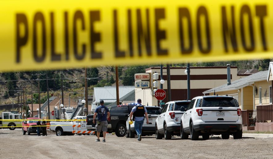 Police and other emergency personnel are seen after a reported shooting in Anaconda, Mont., Friday, Aug. 1, 2025. (Joseph Scheller/The Montana Standard via AP)