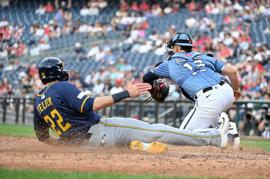 Milwaukee Brewers designated hitter Christian Yelich (22) sliding home to score on Isaac Collins’ double during the ninth inning of an MLB game against the Washington Nationals at Nationals Park in Washington D.C., August 2, 2025. (Photo by All-Pro Reels for Washington Times Sports)