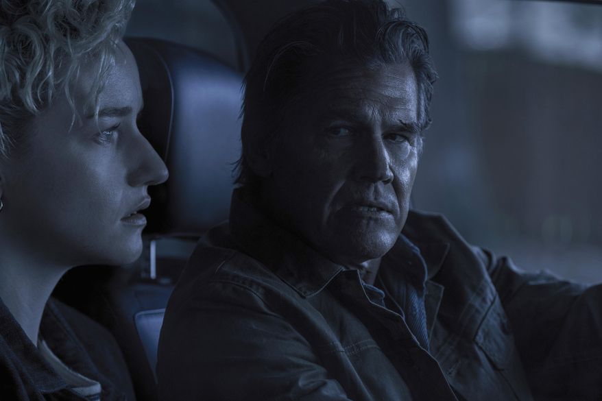 This image released by Warner Bros. Pictures shows Julia Garner, left, and Josh Brolin in a scene from "Weapons." (Quantrell Colbert/Warner Bros. Pictures via AP)