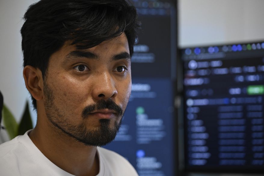 Murtaza Jafari, 25, an Afghan migrant, listens to a question during an interview with The Associated Press, after teaching coding remotely to women currently living in Afghanistan, in Athens, Greece, Wednesday, July 23, 2025. (AP Photo/Michael Varaklas)