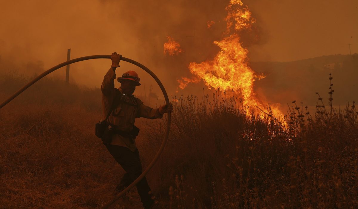 NextImg:Fast-growing brush fire forces thousands to evacuate north of Los Angeles