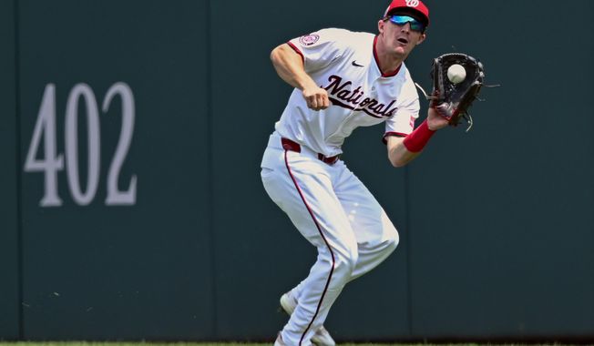 Washington Nationals center fielder Jacob Young catches a deep fly ball hit by the Athletics' Shea Langeliers during the first inning of a baseball game Thursday, Aug. 7, 2025, in Washington. (AP Photo/John McDonnell)
