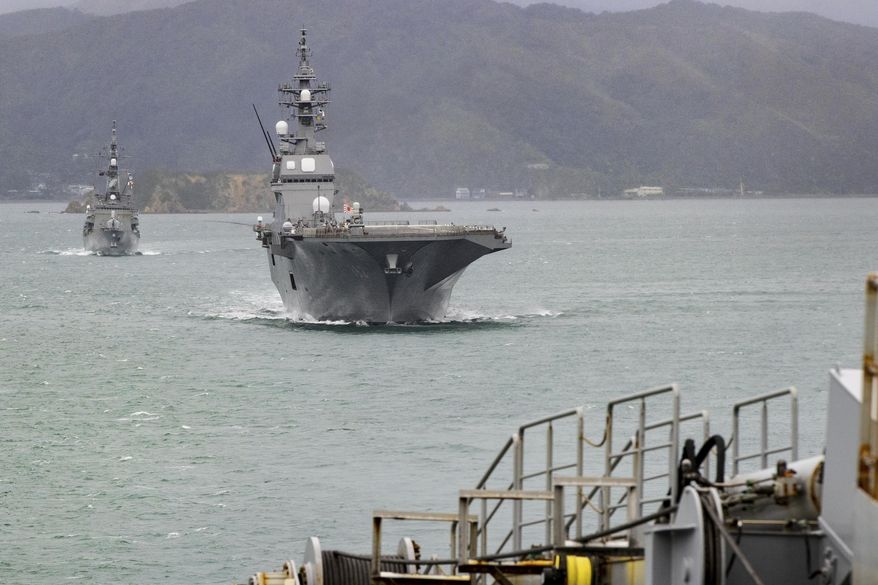 Two ships from the Japan Maritime Self-Defense Force, JS Ise and destroyer JS Suzunami sail into Wellington, New Zealand to begin a three-day ceremonial port visit, Friday, Aug. 8, 2025. (Monique Ford/Stuff via AP)