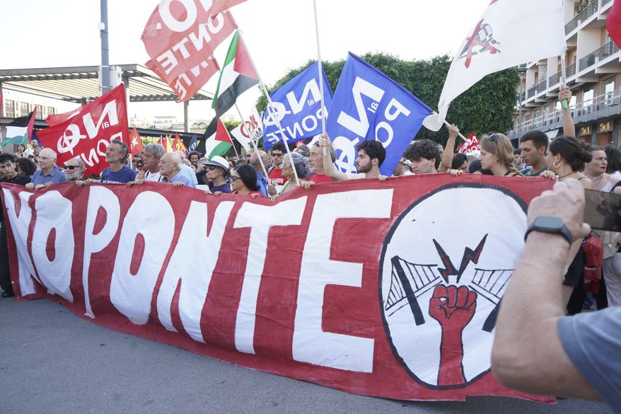 People hold a banner during a demonstration against the bridge in Messina, Italy on Saturday, Aug. 9, 2025 (Francesco Saya/LaPresse via AP)