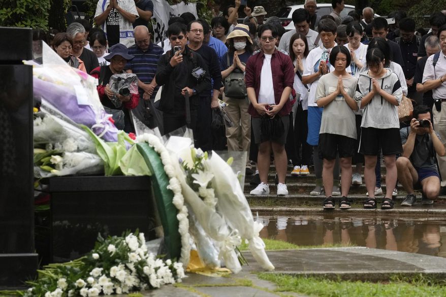 People offer prayers at the Atomic Bomb Hypocenter Park, during a ceremony to commemorate the 80th anniversary of the day an atomic bomb was dropped on Japanese southwestern city, in Nagasaki, Japan Saturday, Aug. 9, 2025.(AP Photo/Eugene Hoshiko)