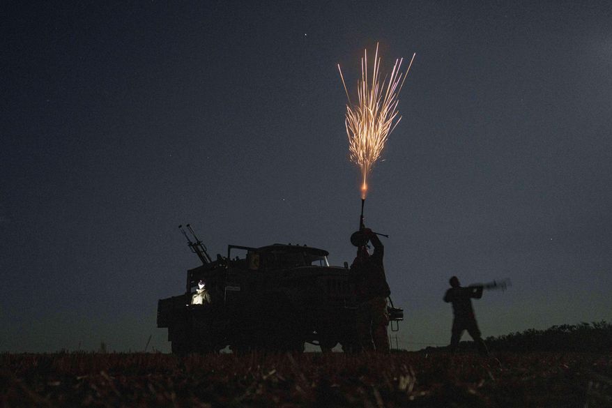 Ukrainian soldiers from air-defence unit of 59th brigade fire at Russian strike drones in Dnipropetrovsk region, Ukraine, Sunday, Aug. 10, 2025. (AP Photo/Evgeniy Maloletka)