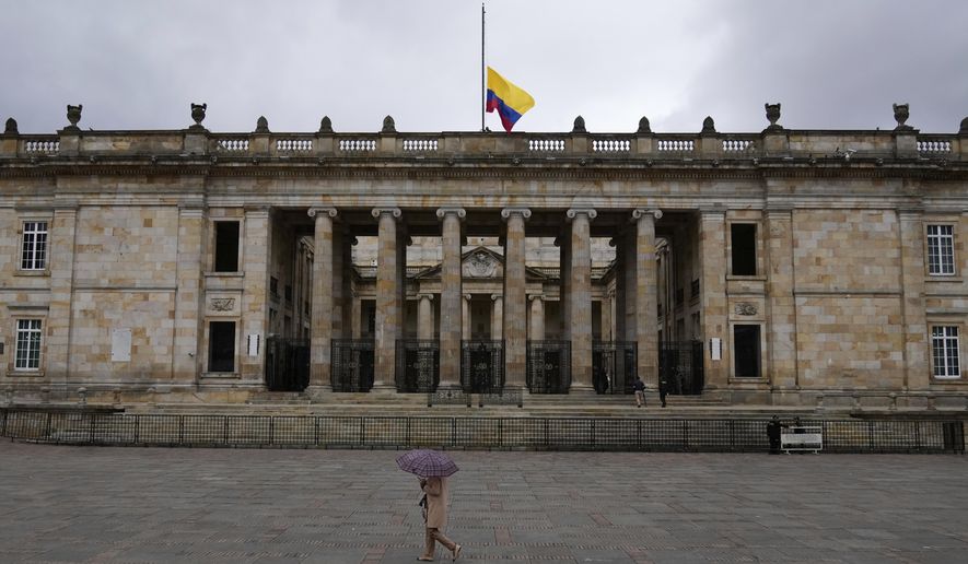 The flag flies at half-staff at Congress in Bogota, Colombia, after the announcement of the death of opposition Sen. Miguel Uribe, more than two months after he was shot during a campaign rally, Monday, Aug. 11, 2025. (AP Photo/Fernando Vergara)