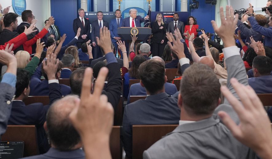 President Donald Trump, center, points to members of the media as he speaks with reporters in the James Brady Press Briefing Room at the White House, Monday, Aug. 11, 2025, in Washington. (AP Photo/Alex Brandon)