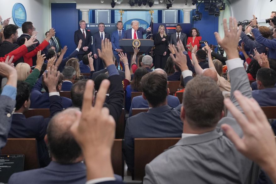 President Donald Trump, center, points to members of the media as he speaks with reporters in the James Brady Press Briefing Room at the White House, Monday, Aug. 11, 2025, in Washington. (AP Photo/Alex Brandon)