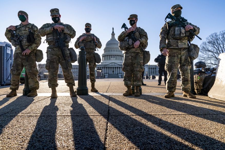National Guard troops and the U.S. Capitol Police keep watch as heightened security remains in effect around the Capitol grounds in Washington, March 3, 2021. (AP Photo/J. Scott Applewhite, File)