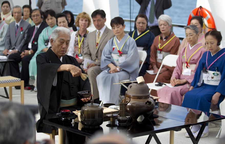 Genshitsu Sen XV, grand tea master of the Urasenke School of Tea, performs a traditional Japanese Tea Ceremony on the USS Arizona Memorial at Pearl Harbor, July 19, 2011, in Honolulu. Pearl Harbor survivors, along with honored guests, participated in the morning ceremony. The tea ceremony honors Americans who lost their lives when Japan attacked Pearl Harbor on Dec. 7, 1941. (AP Photo/Eugene Tanner, File)