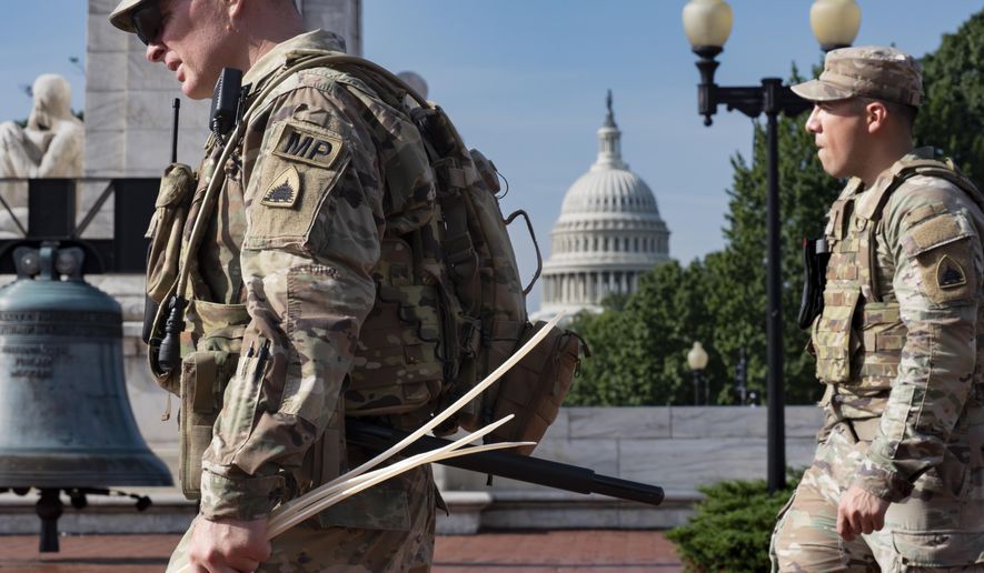 A National Guard military police officer carries a handful of zip ties to use as handcuffs while keeping watch as travelers arrive at Union Station near the Capitol in Washington, Aug. 14, 2025 (AP Photo/J. Scott Applewhite)