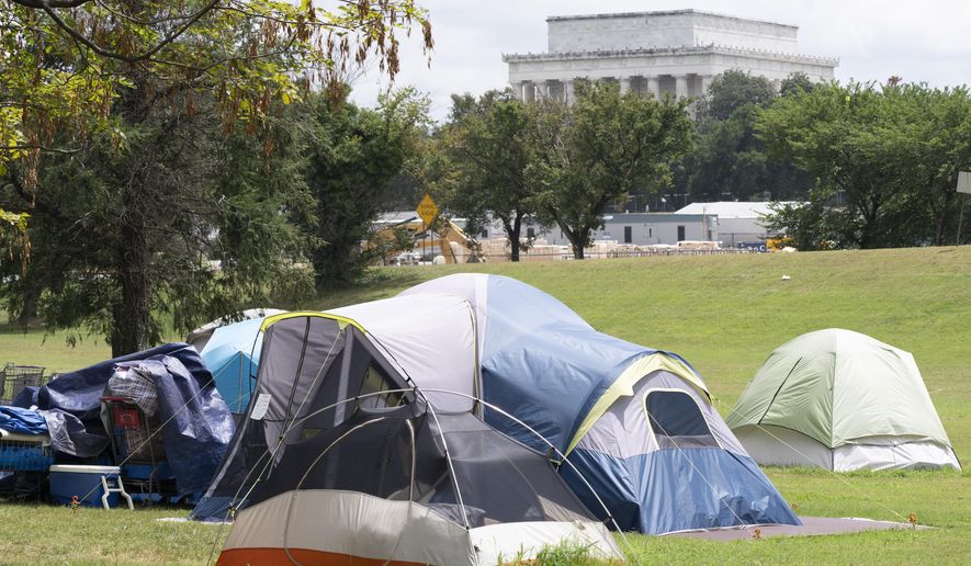 A homeless encampment is seen near the Lincoln Memorial as President Donald Trump uses federal law enforcement and the National Guard eliminate violent crime and unhoused people from the nation's capital, in Washington, Wednesday, Aug. 13, 2025. (AP Photo/J. Scott Applewhite)