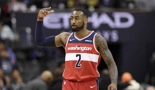 Washington Wizards guard John Wall gestures after hitting a 3-point basket during the second half of the team's NBA basketball game against the Brooklyn Nets, Saturday, Dec. 1, 2018, in Washington. (AP Photo/Nick Wass, File)
