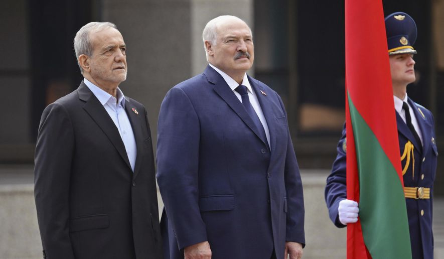 In this photo, released by Belarusian Presidential Press Service, Belarusian President Alexander Lukashenko, center, and Iranian President Masoud Pezeshkian, left, attend a welcome ceremony prior to their talks in Minsk, Belarus, Wednesday, Aug. 20, 2025. (Belarusian Presidential Press Service via AP) **FILE**
