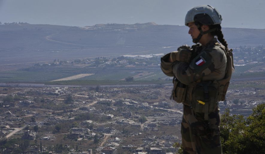 A French U.N. peacekeeper stands on a hill overlooking Kfar Kila, a Lebanese border village destroyed by Israeli airstrikes and a ground offensive, in south Lebanon, Wednesday, Aug. 20, 2025. (AP Photo/Hussein Malla) ** FILE **