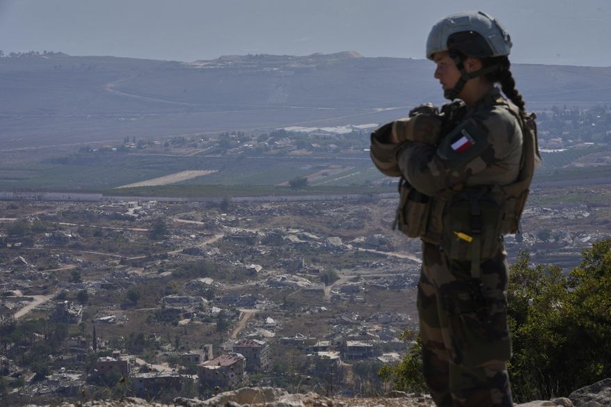 A French U.N. peacekeeper stands on a hill overlooking Kfar Kila, a Lebanese border village destroyed by Israeli airstrikes and a ground offensive, in south Lebanon, Wednesday, Aug. 20, 2025. (AP Photo/Hussein Malla) ** FILE **