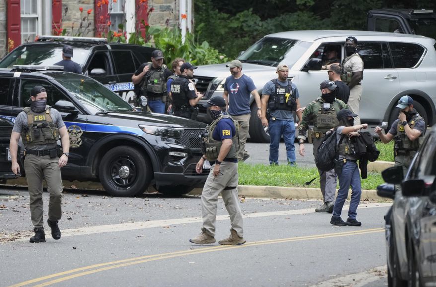 Officers from various federal agencies, including Homeland Security Investigations, FBI, Department of Homeland Security from the Boston Field Office, and U.S. Park Police, prepare for patrols at the U.S. Park Police Rock Creek Station, Thursday, Aug. 21, 2025, in Washington. (AP Photo/Jacquelyn Martin) ** FILE **