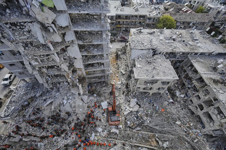 FILE -Israeli soldiers search through the rubble of residential buildings destroyed by an Iranian missile strike in Bat Yam, central Israel, June 15, 2025. (AP Photo/Baz Ratner, File)