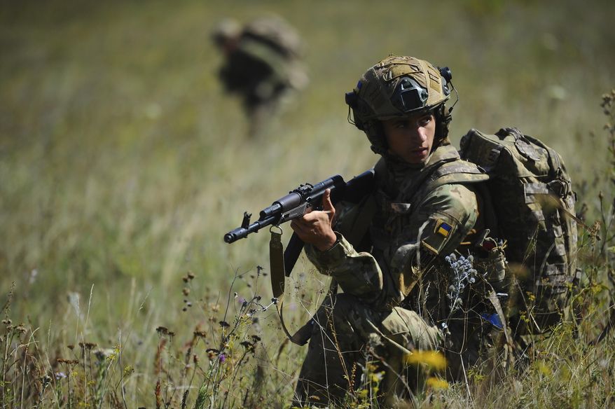 In this photo, taken on Tuesday, Aug. 19, 2025 and provided by Ukraine's 127th Separate Brigade of the Territorial Defence press service, soldiers aged 18 to 24 practice military skills on a training ground near Kharkiv, Ukraine. (Anatolii Lysianskyi/Ukraine's 127th Separate Brigade via AP)