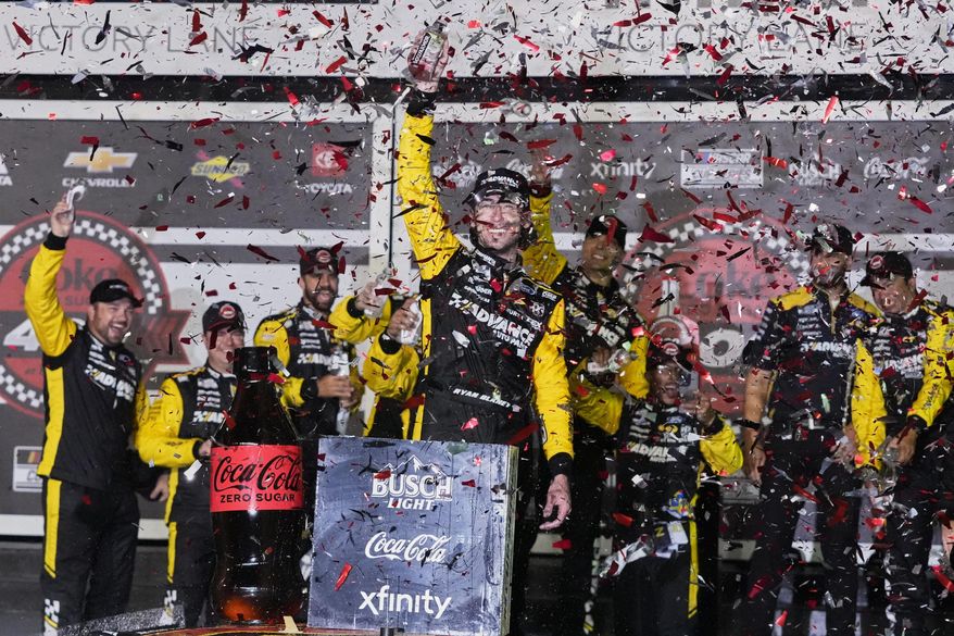 Ryan Blaney, center, celebrates in Victory Lane after winning a NASCAR Cup Series auto race at Daytona International Speedway, Saturday, Aug. 23, 2025, in Daytona Beach, Fla. (AP Photo/John Raoux)