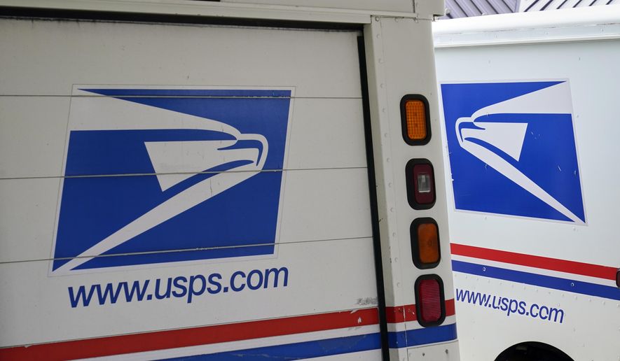 U.S. Postal Service delivery vehicles are parked outside a post office in Boys Town, Neb., Aug. 18, 2020. (AP Photo/Nati Harnik, File)
