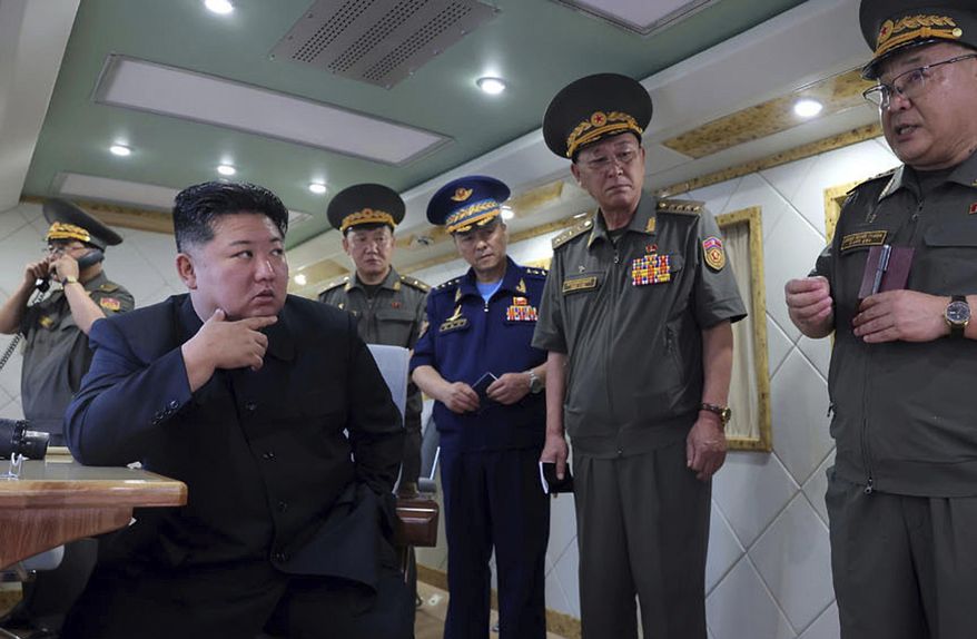 In this photo provided Sunday, Aug. 24, 2025, by the North Korean government, North Korean leader Kim Jong Un, left, supervises the test-firing of two types of new anti-air missiles at undisclosed location, North Korea on Aug. 23, 2025. Independent journalists were not given access to cover the event depicted in this image distributed by the North Korean government. The content of this image is as provided and cannot be independently verified. (Korean Central News Agency/Korea News Service via AP)