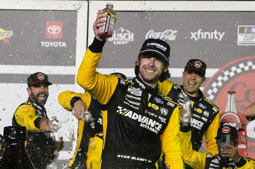 Ryan Blaney, front, celebrates in Victory Lane after winning a NASCAR Cup Series auto race at Daytona International Speedway, Saturday, Aug. 23, 2025, in Daytona Beach, Fla. (AP Photo/John Raoux)