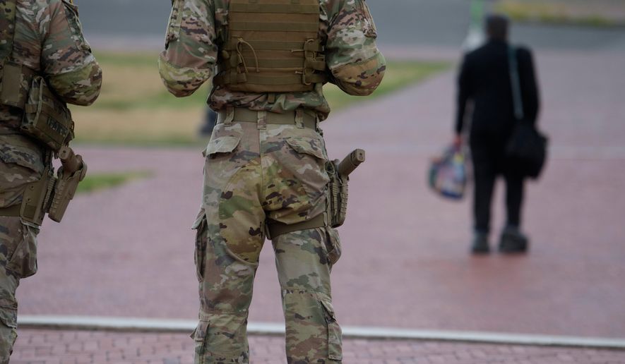 Armed members of the South Carolina National Guard are positioned outside of Union Station in Washington, Sunday, Aug. 24, 2025. (AP Photo/Rod Lamkey, Jr.)