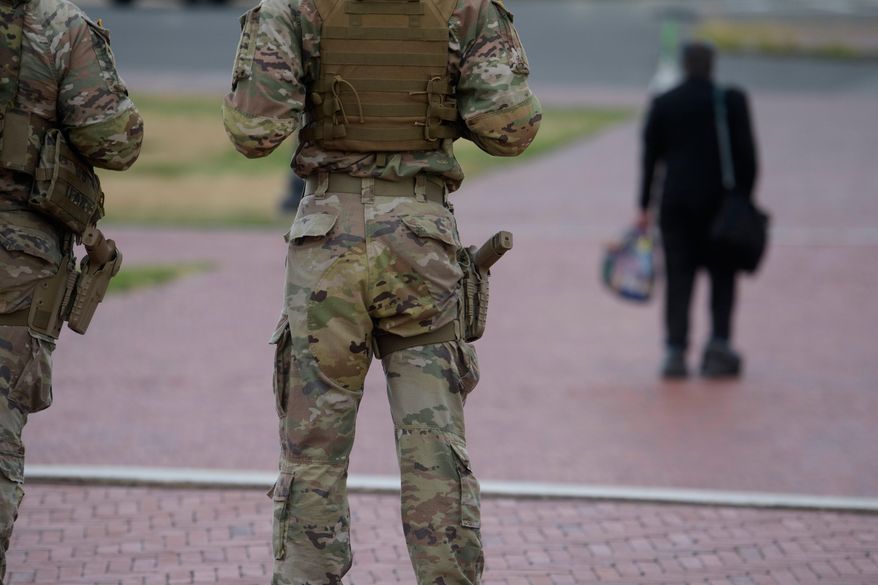 Armed members of the South Carolina National Guard are positioned outside of Union Station in Washington, Sunday, Aug. 24, 2025. (AP Photo/Rod Lamkey, Jr.)