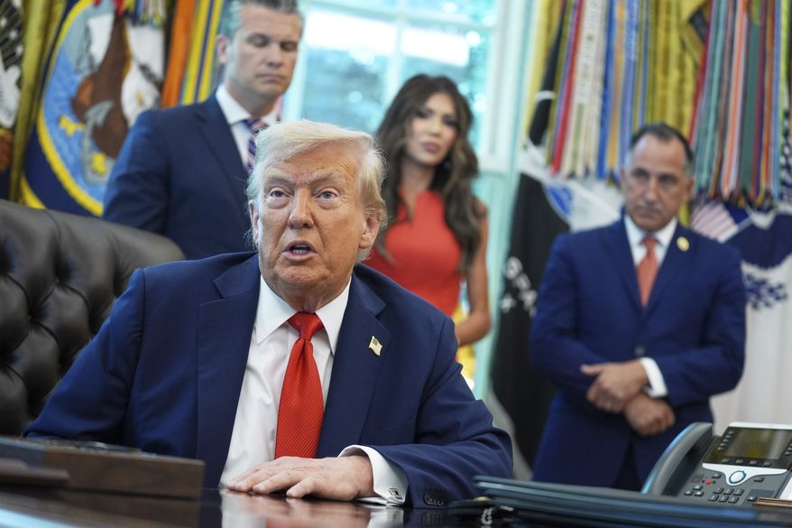 President Donald Trump speaks as he signs executive orders in the Oval Office of the White House, Monday, Aug. 25, 2025, in Washington. Standing with the President from left are, Secretary of Defense Pete Hegseth, Homeland Security Secretary Kristi Noem and Director of U.S. Federal Marshall Service Gadyaces Serralta. (AP Photo/Evan Vucci)