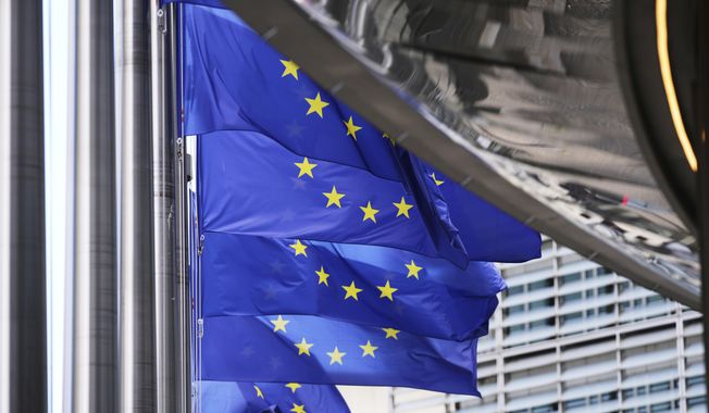 European Union flags flap in the wind outside EU headquarters in Brussels, Thursday, Aug. 21, 2025. (AP Photo/Virginia Mayo) ** FILE **