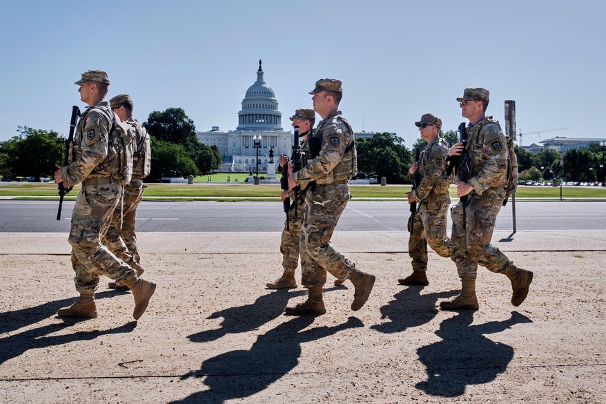 Armed National Guard soldiers from West Virginia patrol the Mall near the Capitol in Washington, as part of President Donald Trump's order to impose federal law enforcement in the nation's capital, Tuesday, Aug. 26, 2025. (AP Photo/J. Scott Applewhite)
