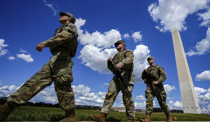 Armed South Carolina National Guardsmen patrol near the Washington Monument, Tuesday, Aug. 26, 2025, in Washington. (AP Photo/Julia Demaree Nikhinson)
