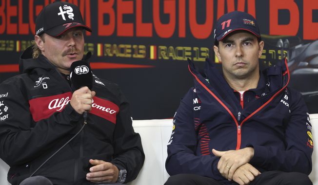 Alfa Romeo driver Valtteri Bottas of Finland, left, and Red Bull driver Sergio Perez of Mexico participate in a media conference ahead of the Formula One Grand Prix at the Spa-Francorchamps racetrack in Spa, Belgium, July 27, 2023. (AP Photo/Geert Vanden Wijngaert, file)