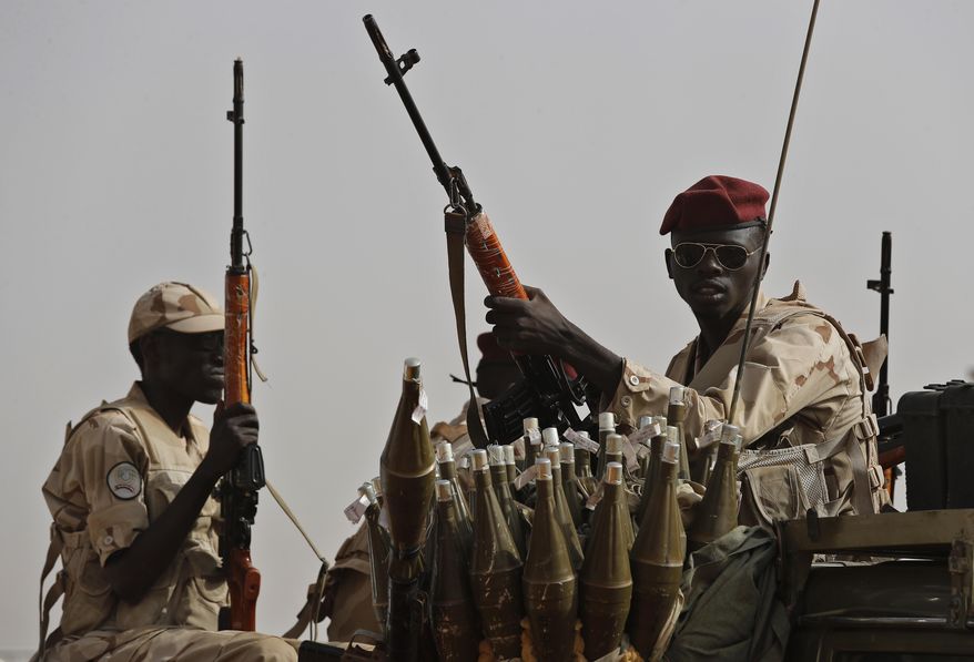 FILE - Sudanese soldiers from the Rapid Support Forces unit secure the area where Gen. Mohammed Hamdan Dagalo attends a military-backed tribe's rally, in the East Nile province, Sudan, June 22, 2019. (AP Photo/Hussein Malla, File)