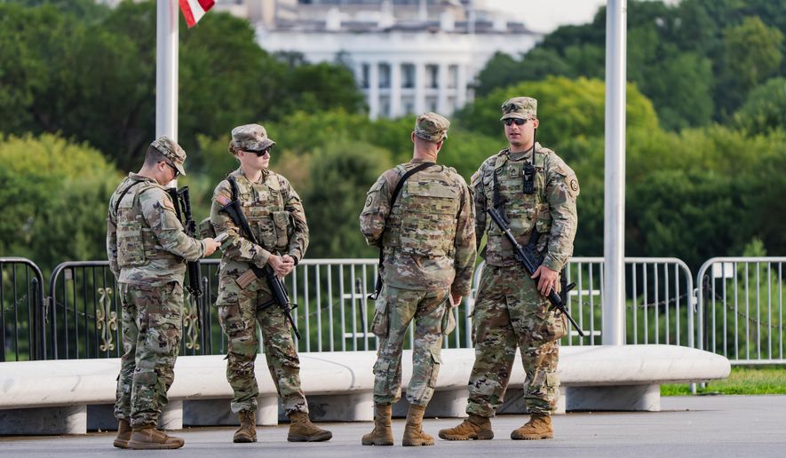 With the White House in the distance, National Guard troops patrol the Mall as part of President Donald Trump's order to impose federal law enforcement in the nation's capital, in Washington, Thursday, Aug. 28, 2025. (AP Photo/J. Scott Applewhite)