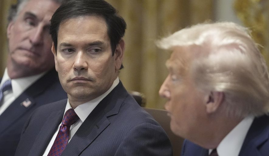 President Donald Trump speaks during a cabinet meeting, Tuesday, Aug. 26, 2025, at the White House in Washington, as from left, Secretary of Interior Doug Burgum and Secretary of State Marco Rubio, look on. (AP Photo/Mark Schiefelbein)