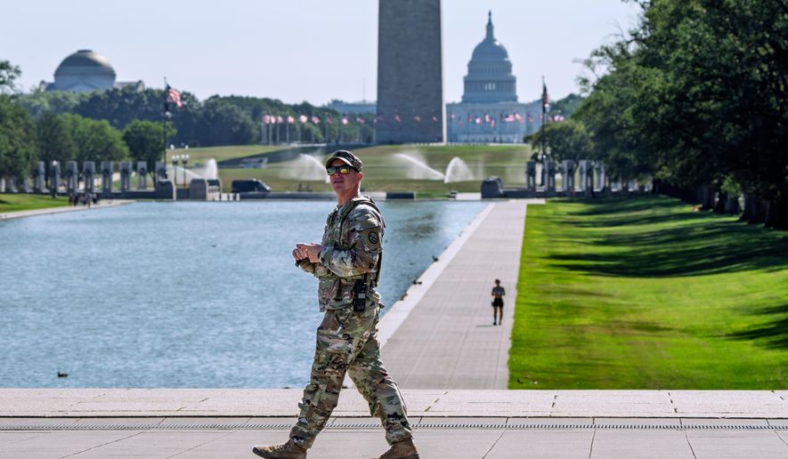 A member of the West Virginia National Guard gazes up at the Lincoln Memorial on the National Mall in Washington, as part of President Donald Trump's order to use federal law enforcement to expel homeless people and rid the nation's capital of violent crime, Monday, Aug. 25, 2025. (AP Photo/J. Scott Applewhite) **FILE**