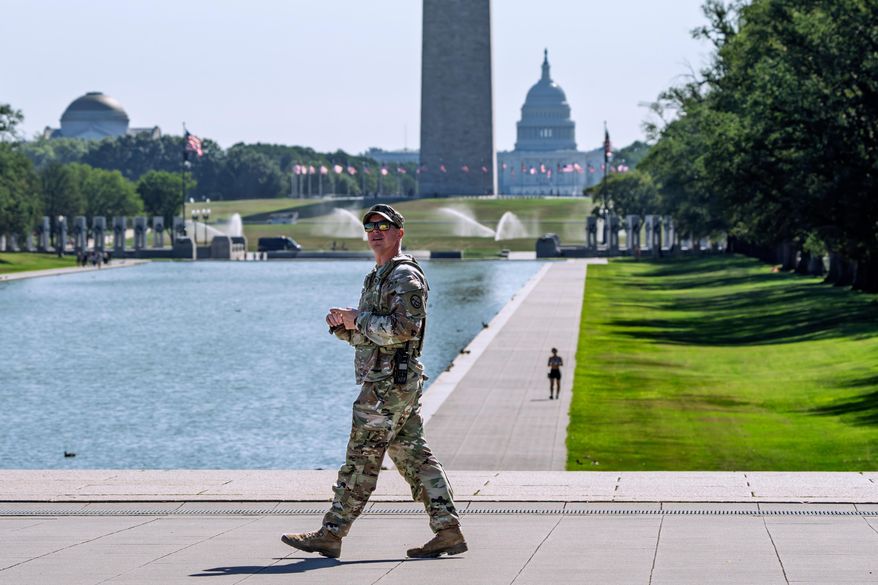 A member of the West Virginia National Guard gazes up at the Lincoln Memorial on the National Mall in Washington, as part of President Donald Trump's order to use federal law enforcement to expel homeless people and rid the nation's capital of violent crime, Monday, Aug. 25, 2025. (AP Photo/J. Scott Applewhite) **FILE**