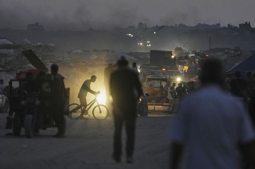 Displaced Palestinians fleeing northern Gaza Strip move with their belongings along the Sea Road, in Gaza City, Monday, Sept. 1, 2025. (AP Photo/Jehad Alshrafi)