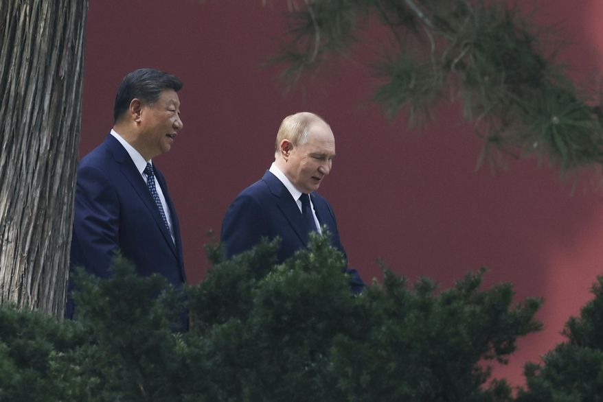 Russian President Vladimir Putin, right, speaks with Chinese President Xi Jinping during a walk at the Zhongnanhai leadership compound in Beijing, China, Tuesday, Sept. 2, 2025. (Alexander Kazakov, Sputnik, Kremlin Pool Photo via AP)