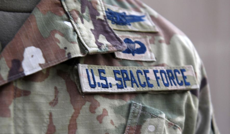 In this photo released by the U.S. Air Force, Capt. Ryan Vickers stands for a photo to display his new service tapes after taking his oath of office to transfer from the U.S. Air Force to the U.S. Space Force at Al-Udeid Air Base, Qatar, Sept. 1, 2020. (Staff Sgt. Kayla White/U.S. Air Force via AP, File)