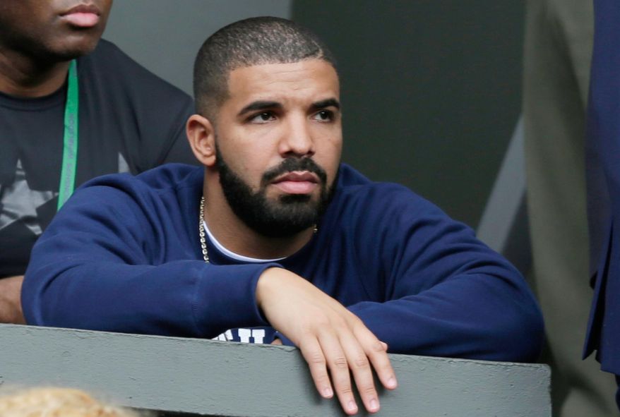 Rapper Drake watches the ladies singles match between Serena Williams, of the United States, and Victoria Azarenka,of Belarus, at the All England Lawn Tennis Championships in Wimbledon, London, Tuesday, July 7, 2015. (AP Photo/Pavel Golovkin, File)
