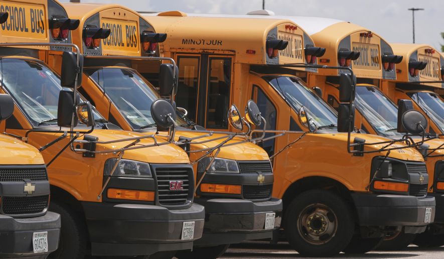 FILE - School buses are lined up in a storage lot, Aug. 14, 2025, in Manchester, N.H. (AP Photo/Charles Krupa, File)