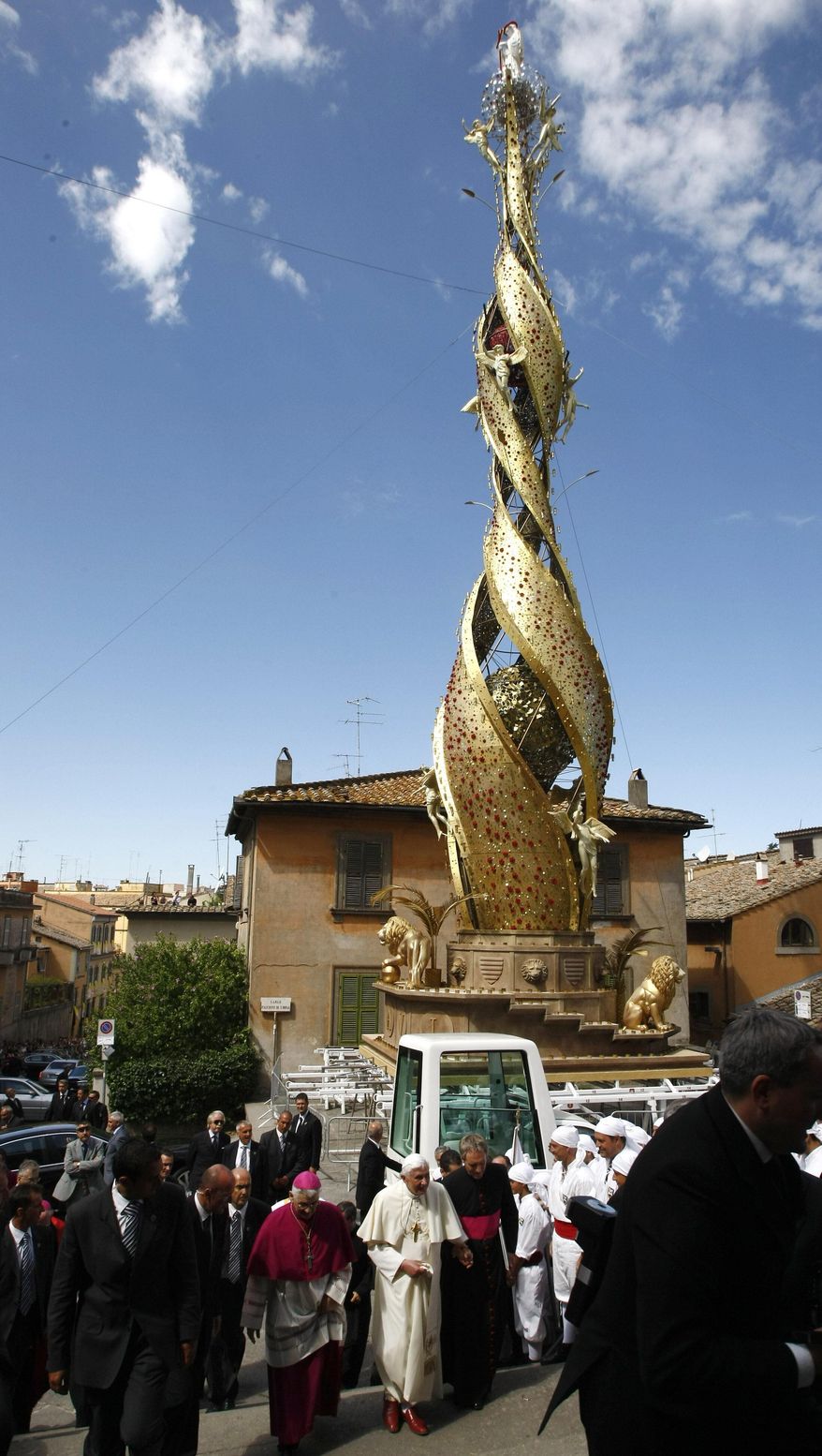 FILE - Pope Benedict XVI walks past the "Machine of St. Rose" (Macchina Santa Rosa), during his visit at Viterbo, central Italy, Sunday, Sept. 6, 2009. (AP Photo/Pier Paolo Cito, Pool, File)