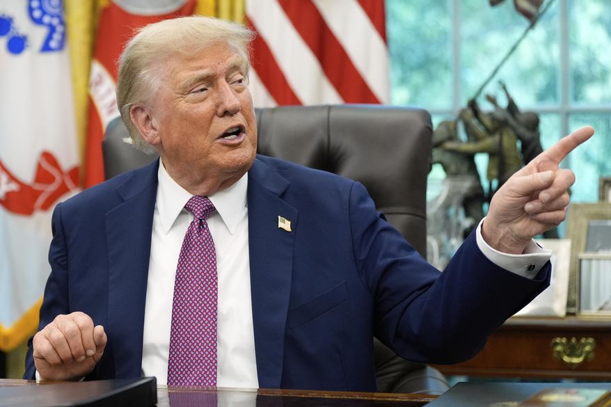 President Donald Trump point to a G20 Miami 2026 poster as he speaks in the Oval Office of the White House, Friday, Sept. 5, 2025, in Washington. (AP Photo/Alex Brandon) **FILE**
