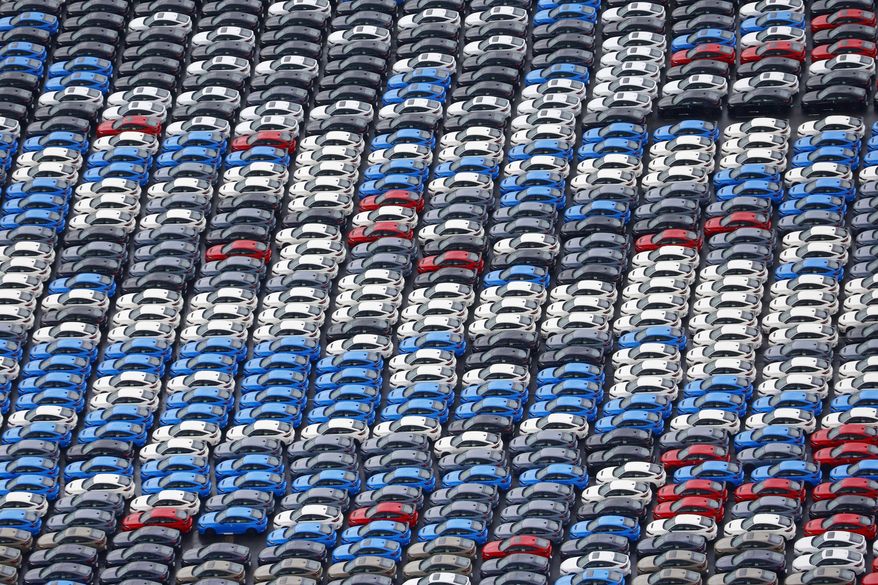 Vehicles are parked for export at a Yokohama port, near Tokyo on Aug. 1, 2025. (Takuto Kaneko/Kyodo News via AP)