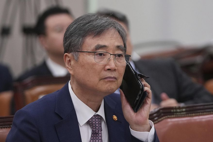 South Korean Foreign Minister Cho Hyun holds his mobile phone before a session of the Foreign Affairs and Unification Committee at the National Assembly in Seoul, South Korea, Monday, Sept. 8, 2025. (AP Photo/Lee Jin-man)